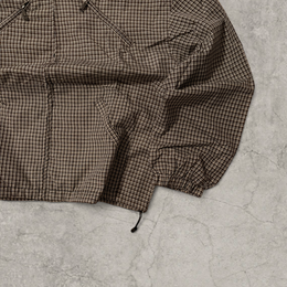 Black and brown checkered gorpcore jacket hood and zip.