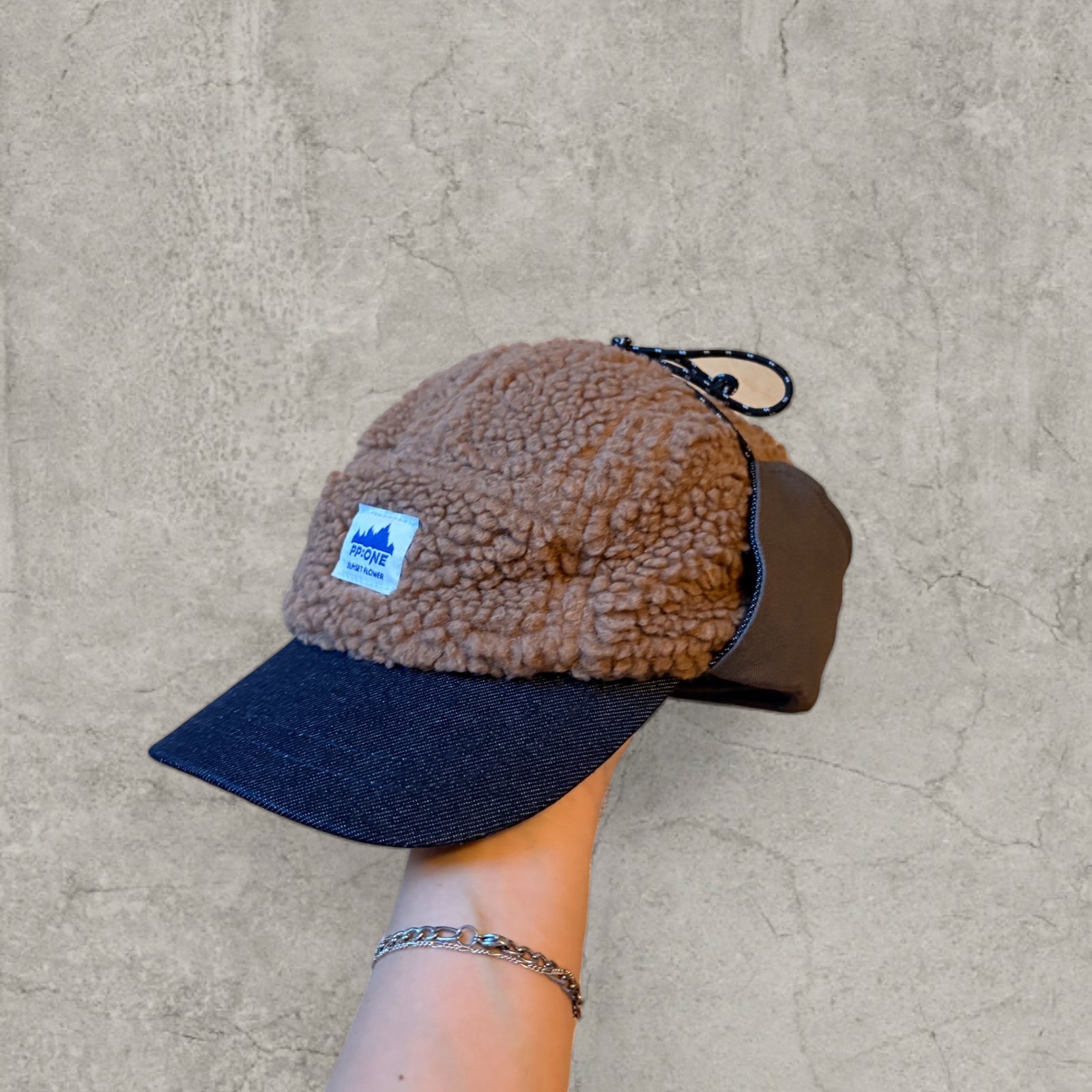 Trapper Russian cap brown/beige fleece and grey ear flaps.