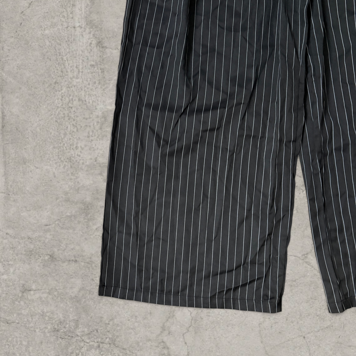 Wide-leg pinstriped tailored trousers in black with white pinstripe