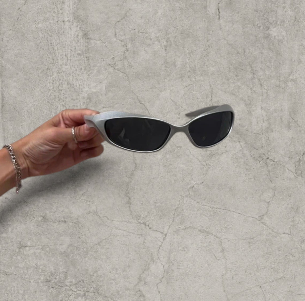 Wrap-around UV400 sunglasses in silver, black lenses one size
