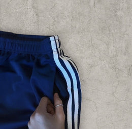 Baggy relaxed fit trousers with white stripes in dark blue