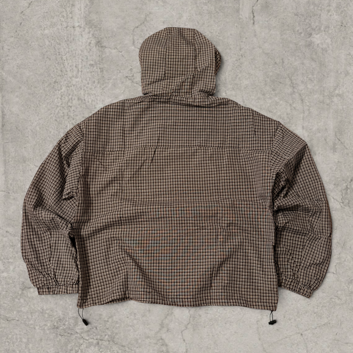 Black and brown checkered gorpcore jacket hood and zip.