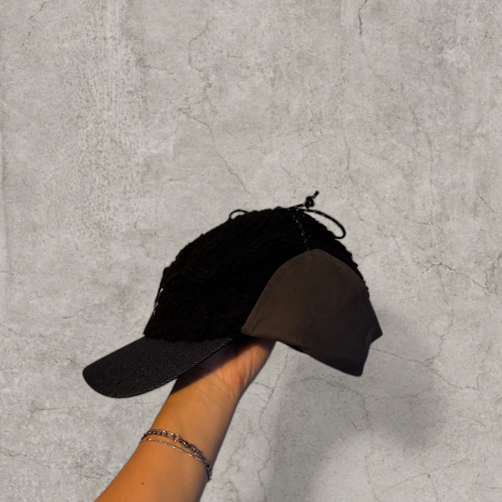 Trapper Russian cap black fleece and navy ear flaps.