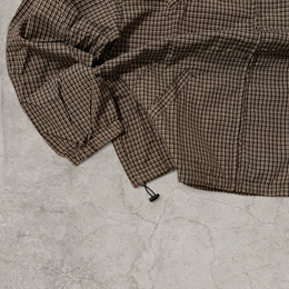 Black and brown checkered gorpcore jacket hood and zip.
