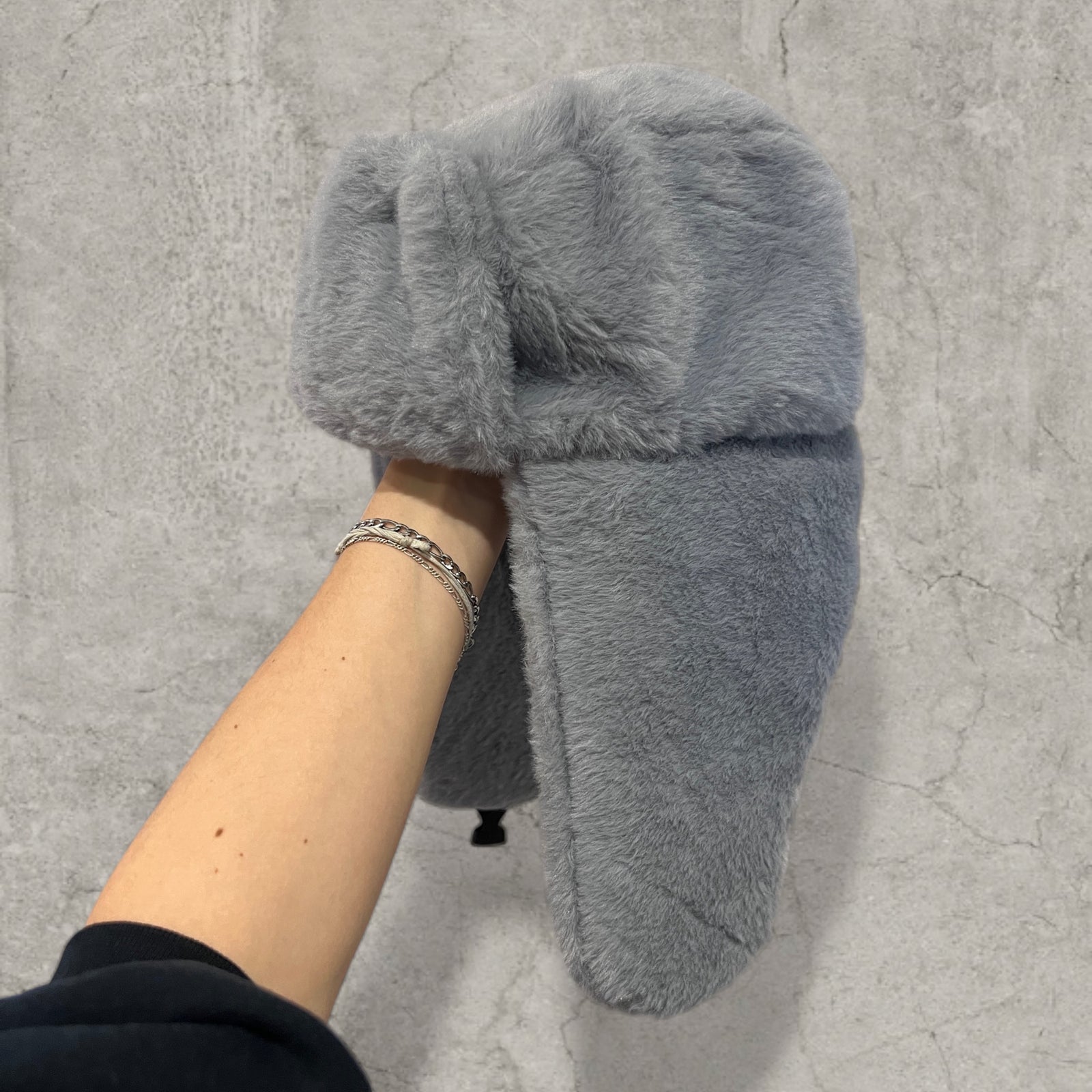 Russian ushanka hat in grey faux fur.