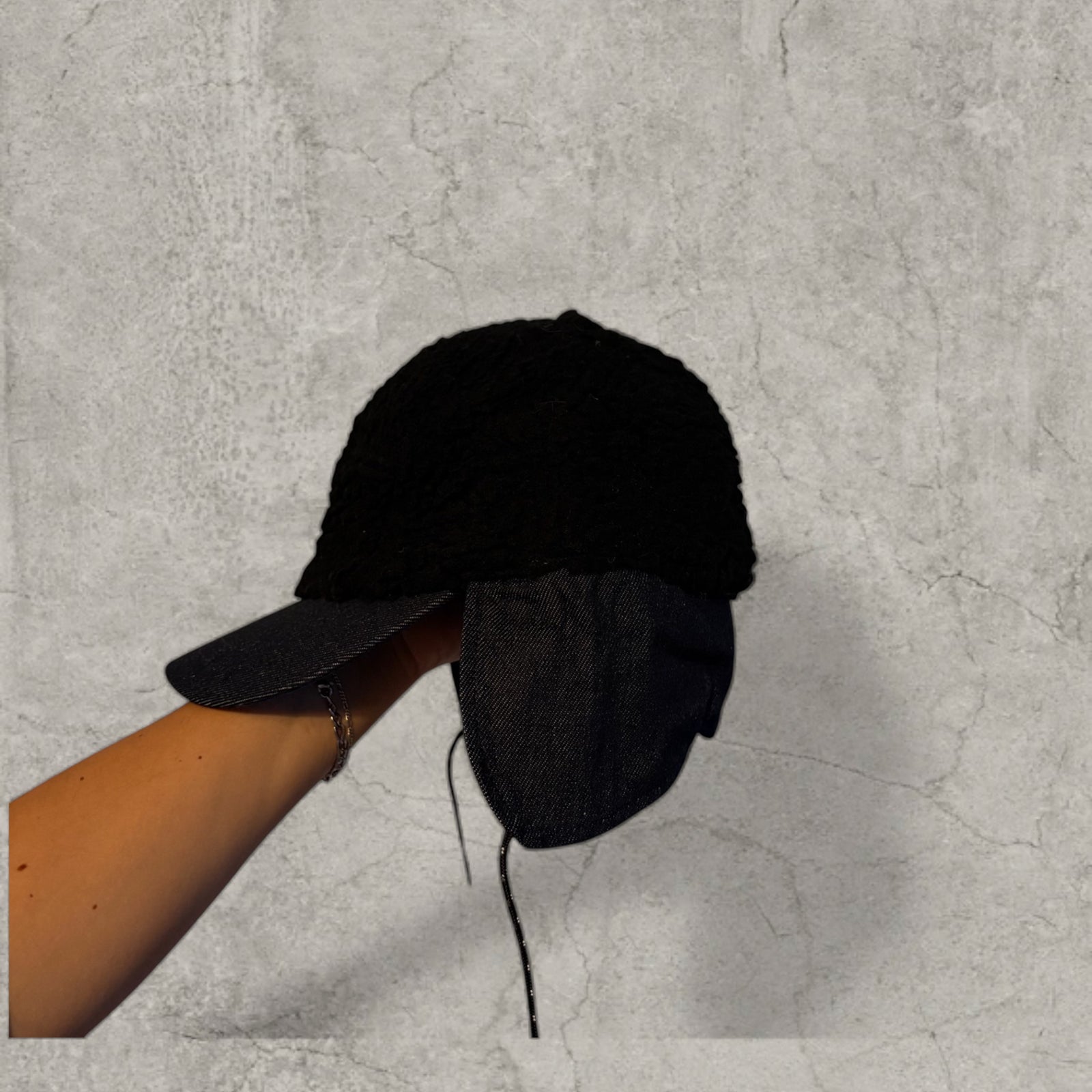 Trapper Russian cap black fleece and navy ear flaps.