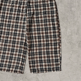 Wide leg checkered plaid trousers with elasticated waist in brown.