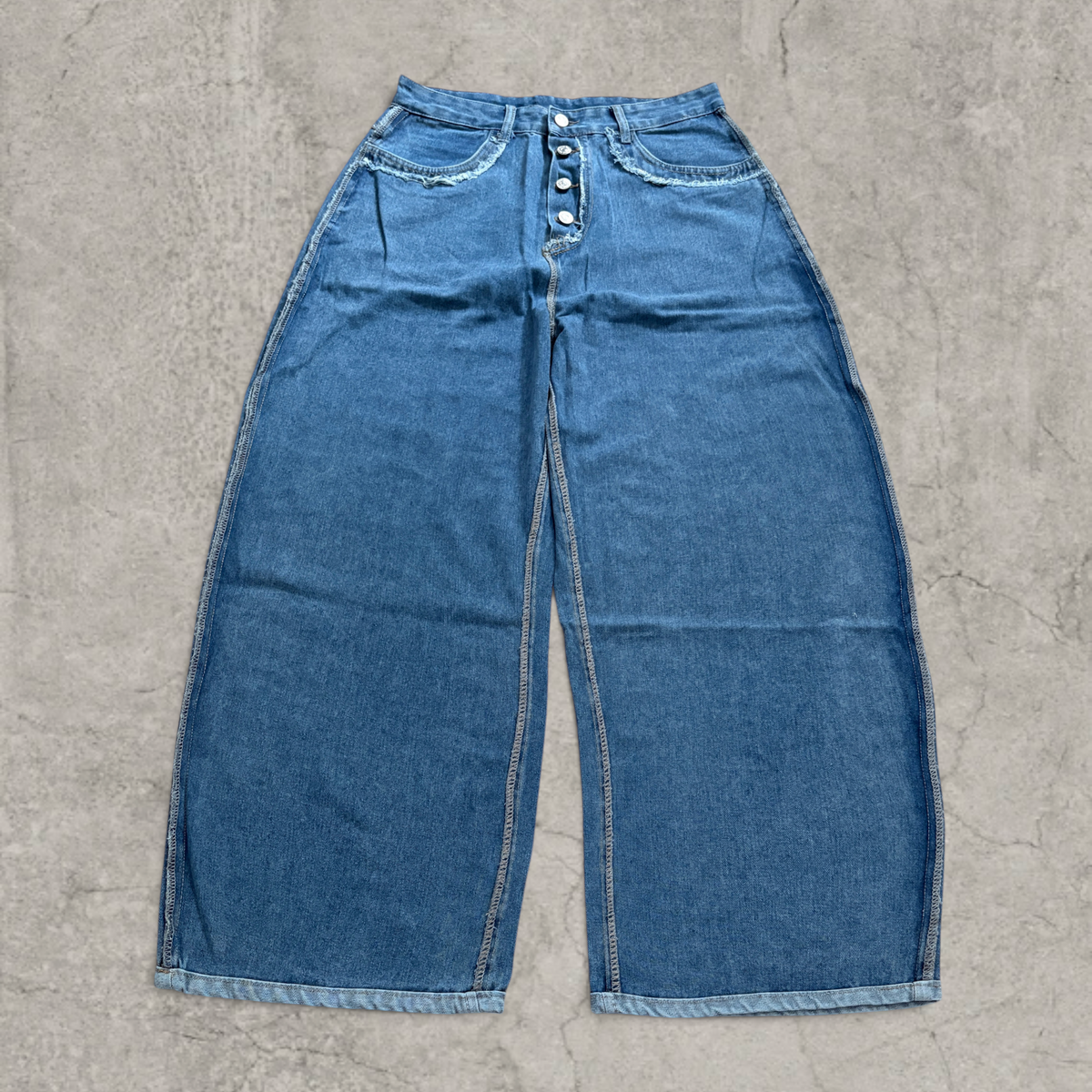 Wide-leg skater jeans in washed blue with raw hem.