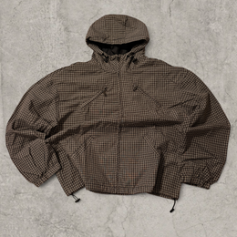 Black and brown checkered gorpcore jacket hood and zip.