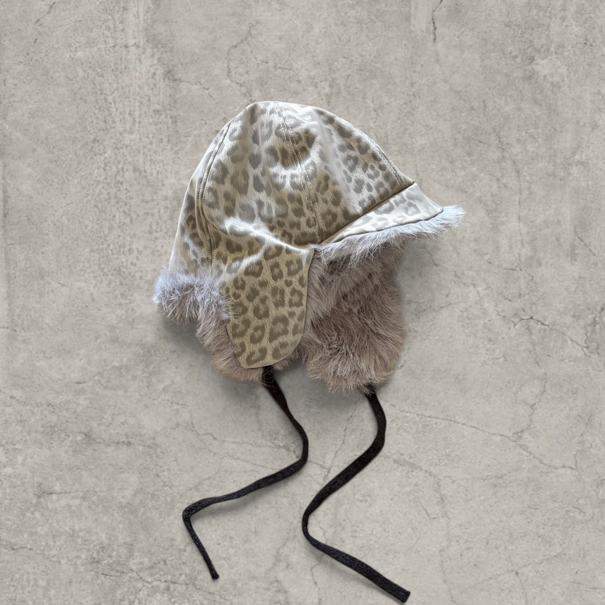 Russian trapper bonnet hat in grey silver animal leopard print with grey fur.