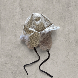 Russian trapper bonnet hat in grey silver animal leopard print with grey fur.