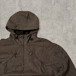 Black and brown checkered gorpcore jacket hood and zip.
