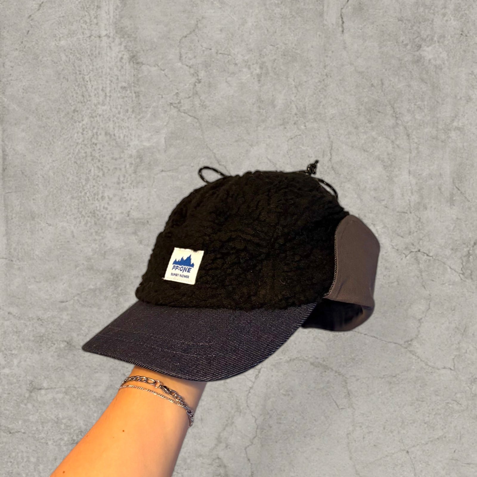 Trapper Russian cap black fleece and navy ear flaps.