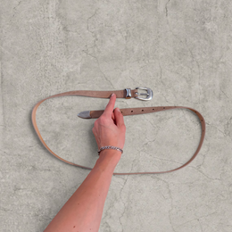 Smart tailored formal belt in beige with silver trim.