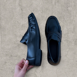 Faux leather penny dress loafers shoes in black.