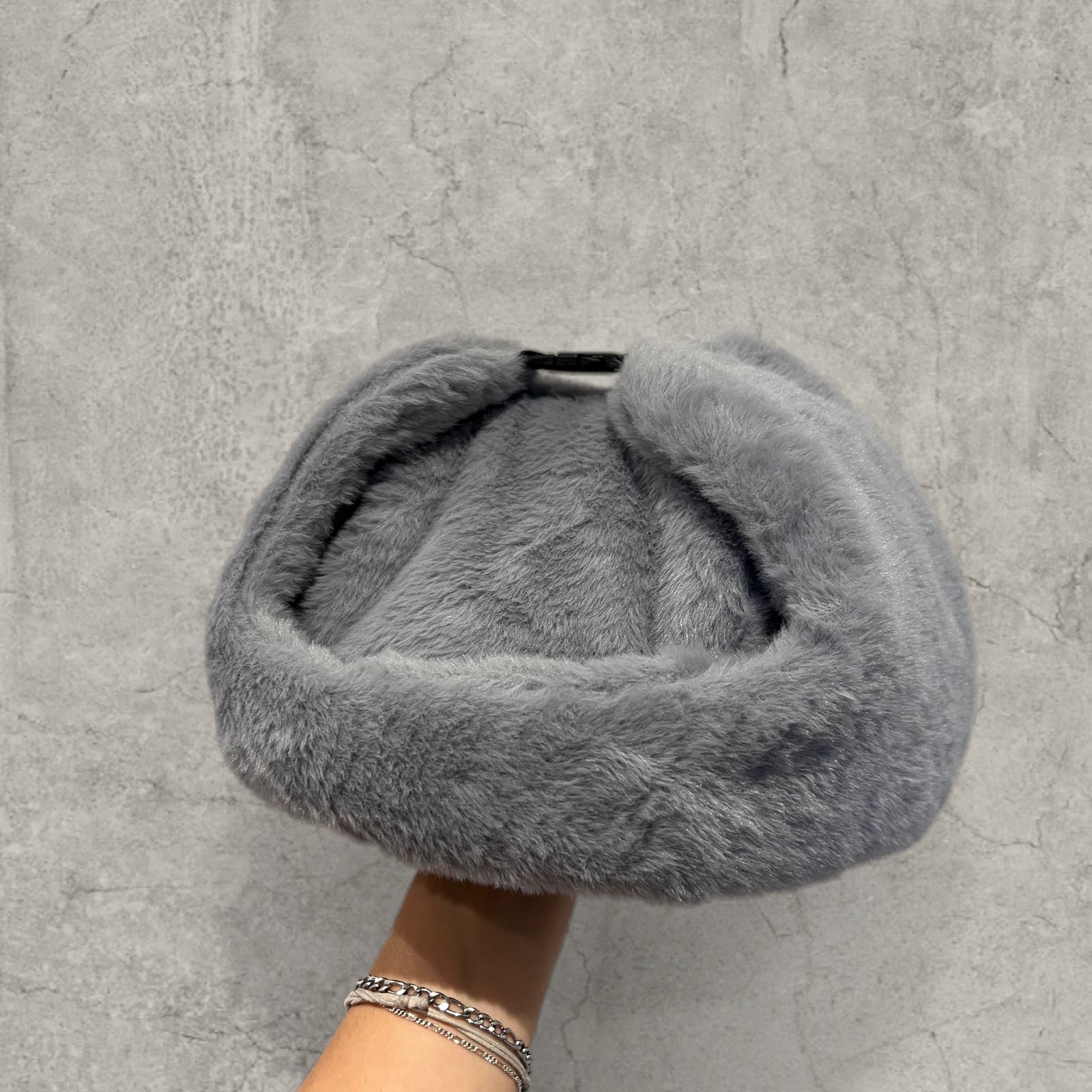 Russian ushanka hat in grey faux fur.