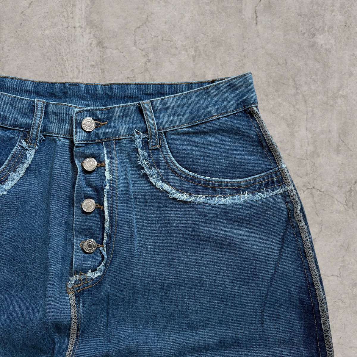 Wide-leg skater jeans in washed blue with raw hem.