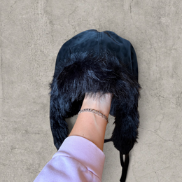 Russian trapper bonnet hat in black animal leopard print with black fur.