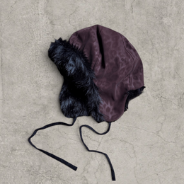 Russian trapper bonnet hat in dark brown animal leopard print with black fur.
