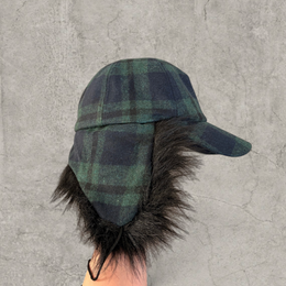 Russian ushanka trapper hat in dark green plaid with black faux fur.