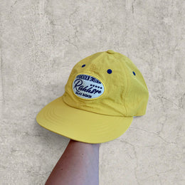 Vintage style baseball cap in yellow with navy blue Scandinavian logo.