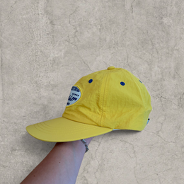 Vintage style baseball cap in yellow with navy blue Scandinavian logo.
