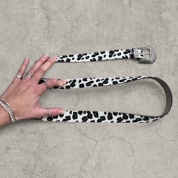 Vintage style faux leather western cowboy belt in white/black leopard print with silver trim.