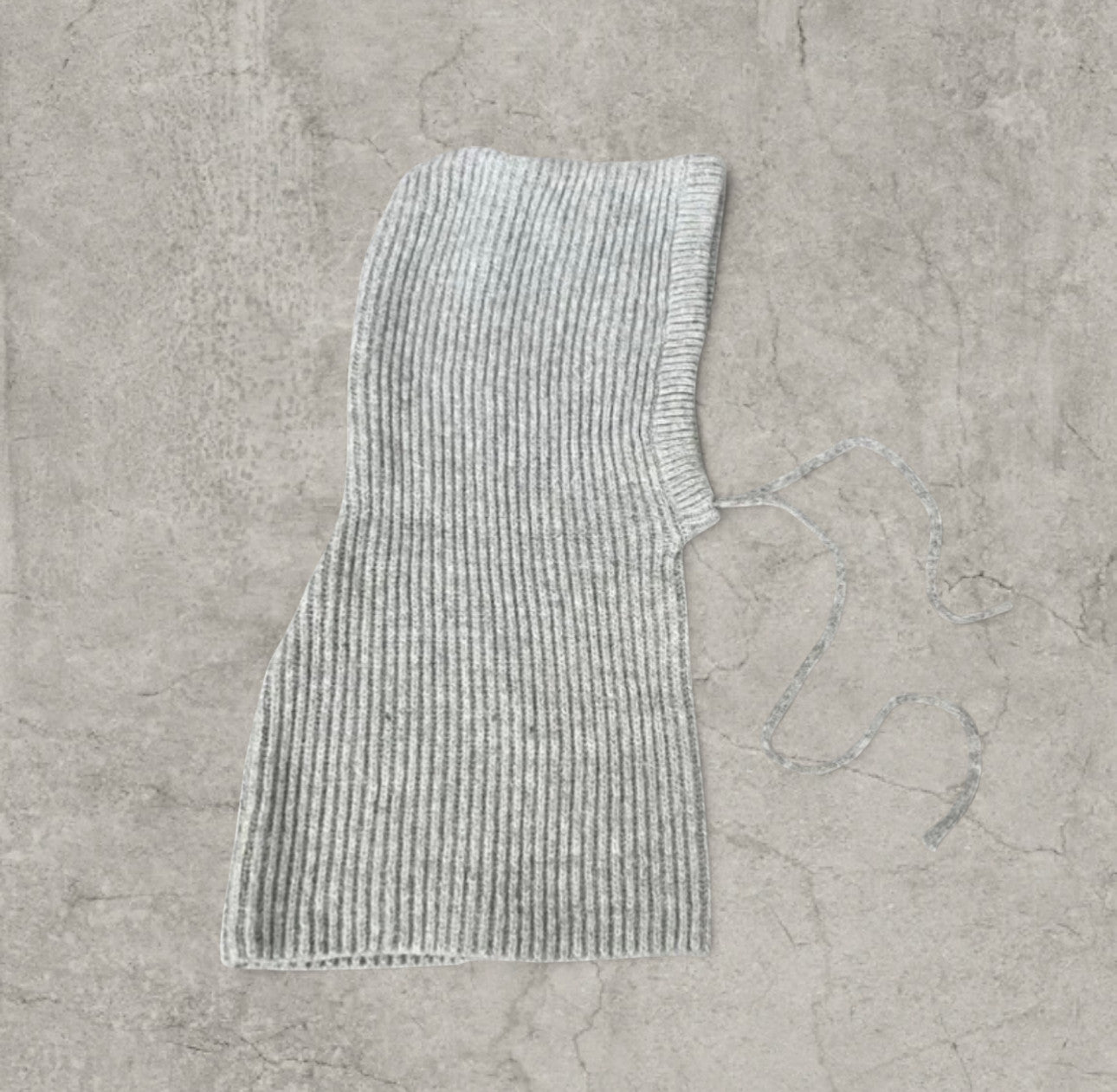 Knitted hooded snood scarf bonnet hat with drawstring in light grey.