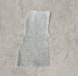 Knitted hooded snood scarf bonnet hat with drawstring in light grey.