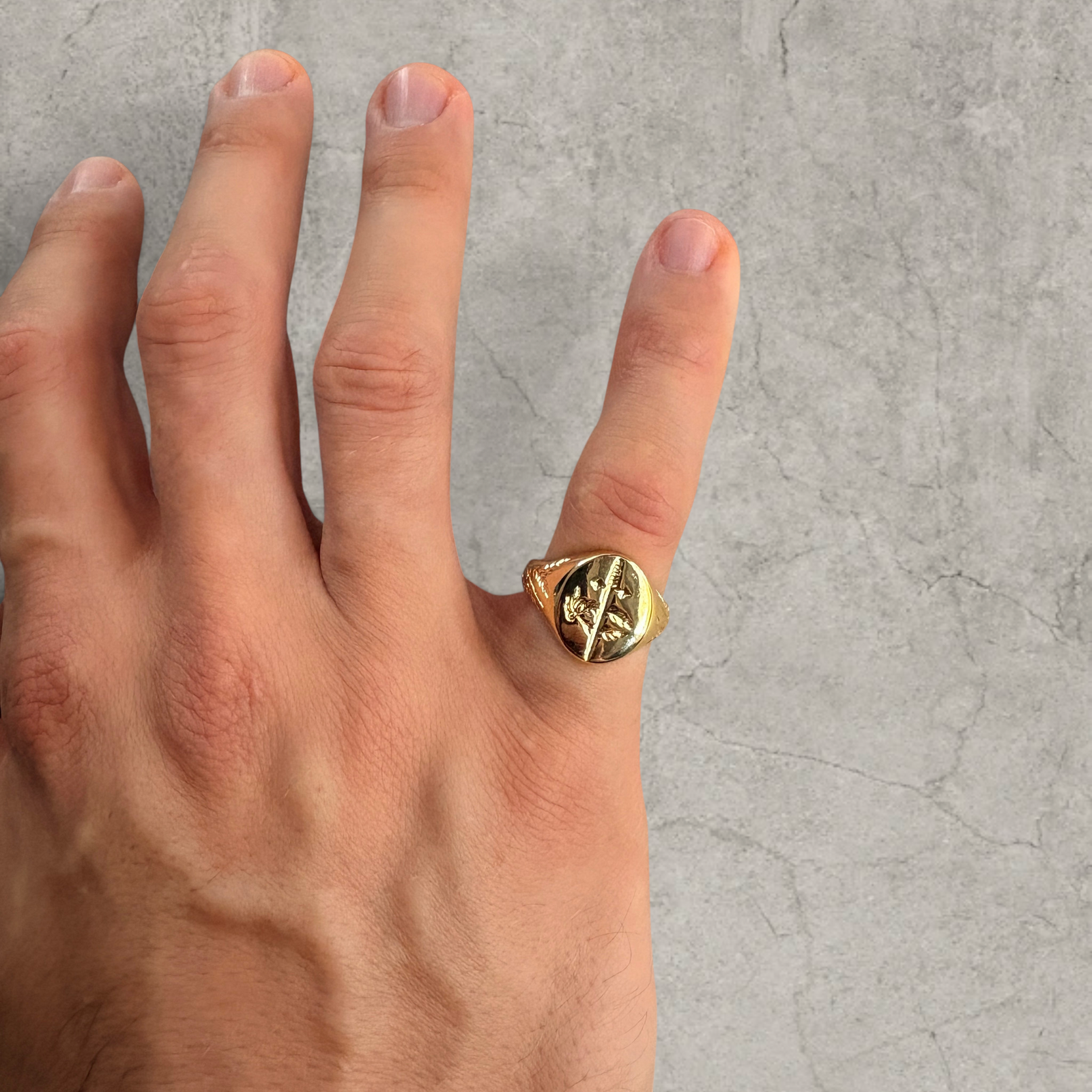 Colour stainless steel signet ring in gold with sword engraved emblem.
