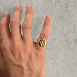 Colour stainless steel signet ring in gold with sword engraved emblem.