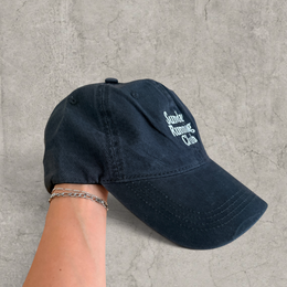 Baseball cap with Sunday Running Club logo in black.