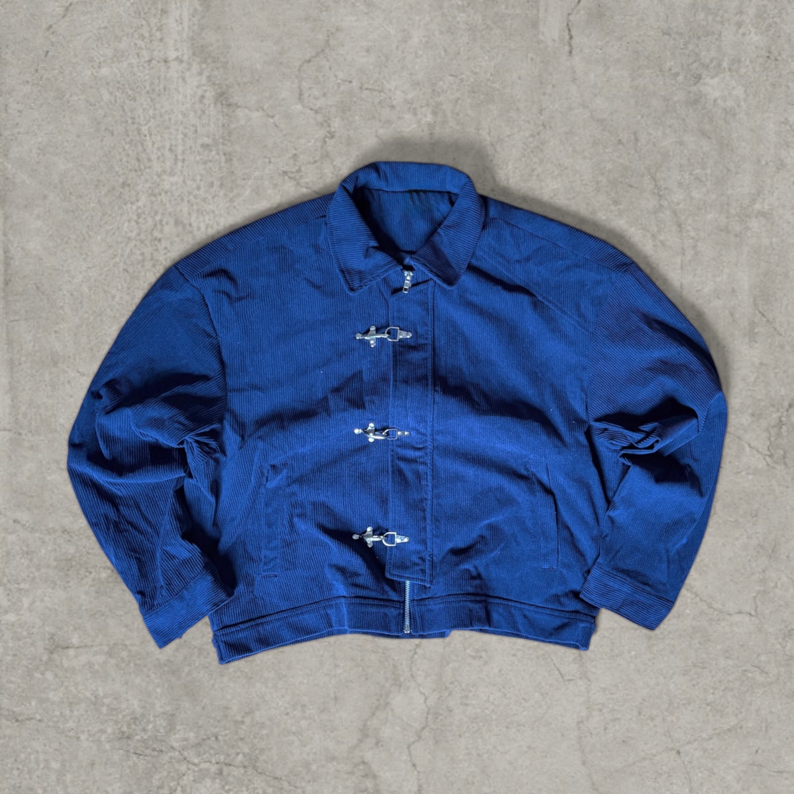 Collared bomber jacket with silver clasp fastenings in navy blue