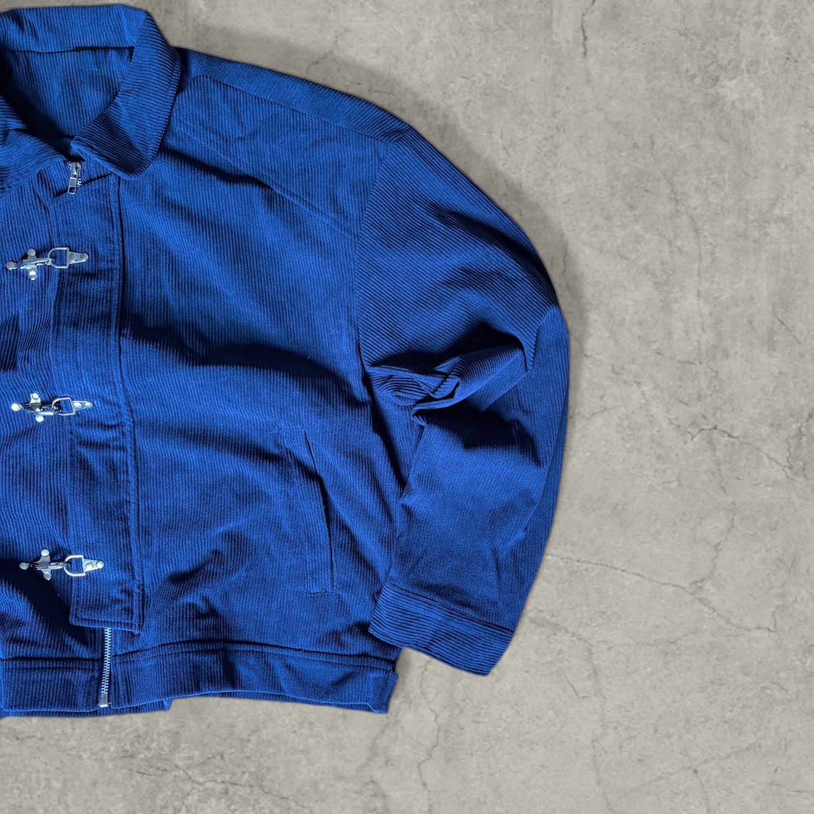 Collared bomber jacket with silver clasp fastenings in navy blue