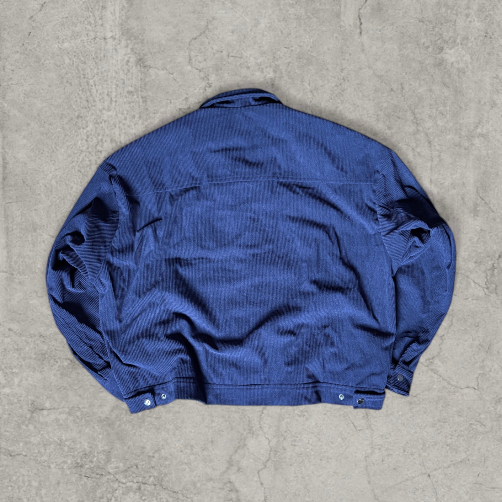Collared bomber jacket with silver clasp fastenings in navy blue