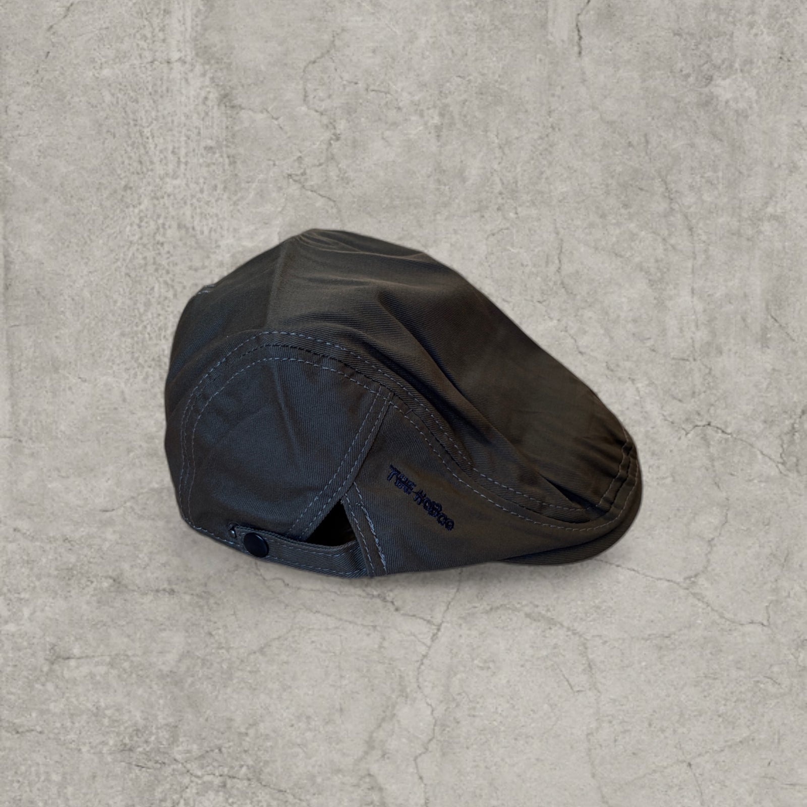 Flat cap in khaki green with black embroidery