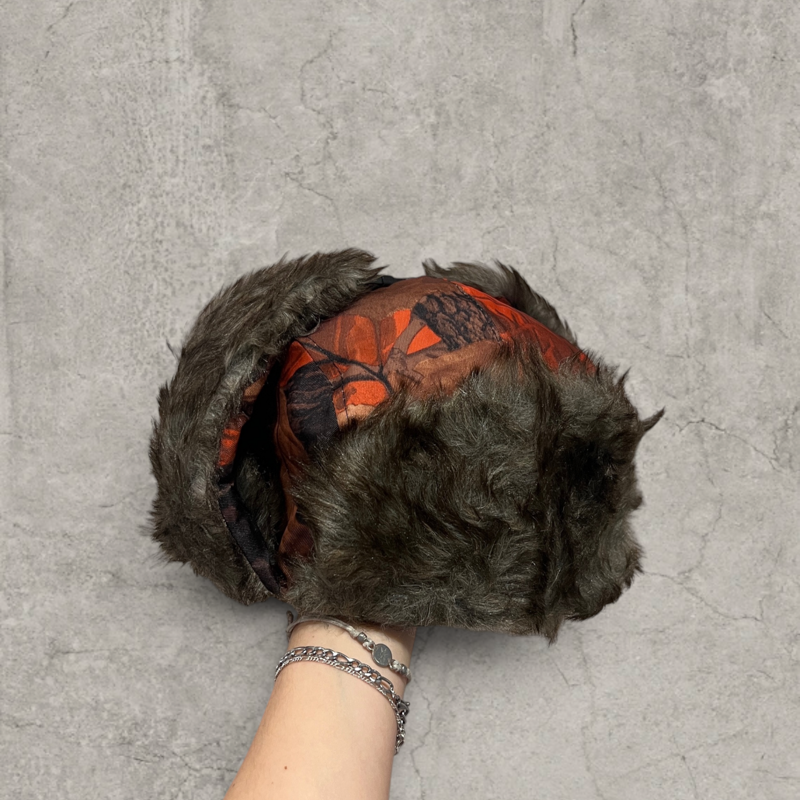 Russian ushanka hat in red/black camo tree print with grey faux fur.