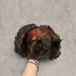 Russian ushanka hat in red/black camo tree print with grey faux fur.