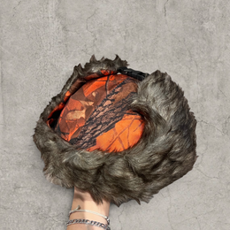 Russian ushanka hat in red/black camo tree print with grey faux fur.