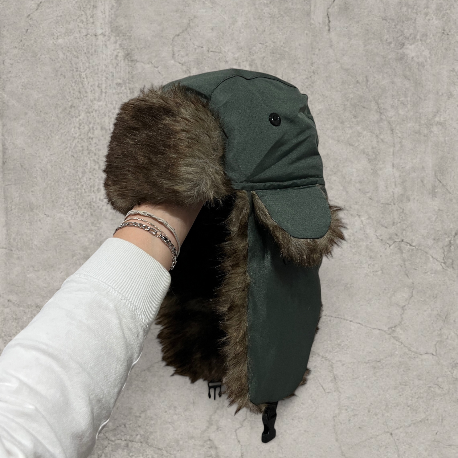 Russian ushanka hat in dark green with grey faux fur.