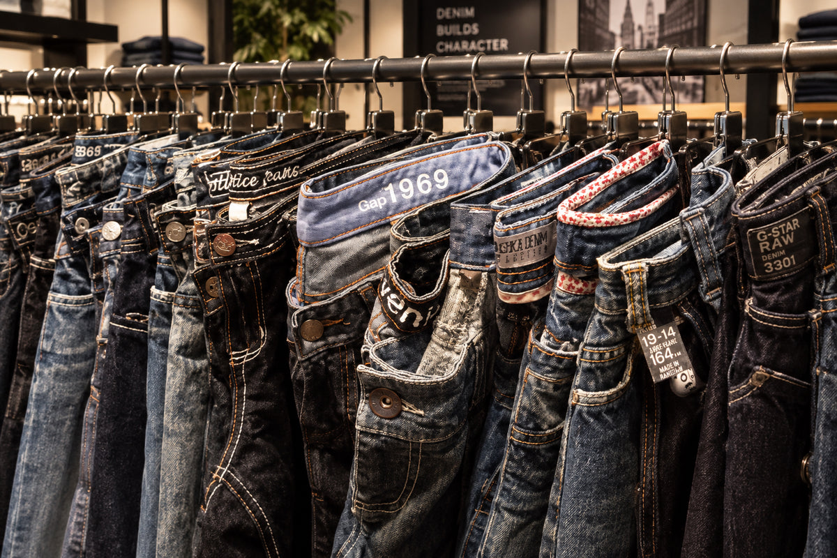 Close up of baggy jeans on a clothing rail in a vintage shop.