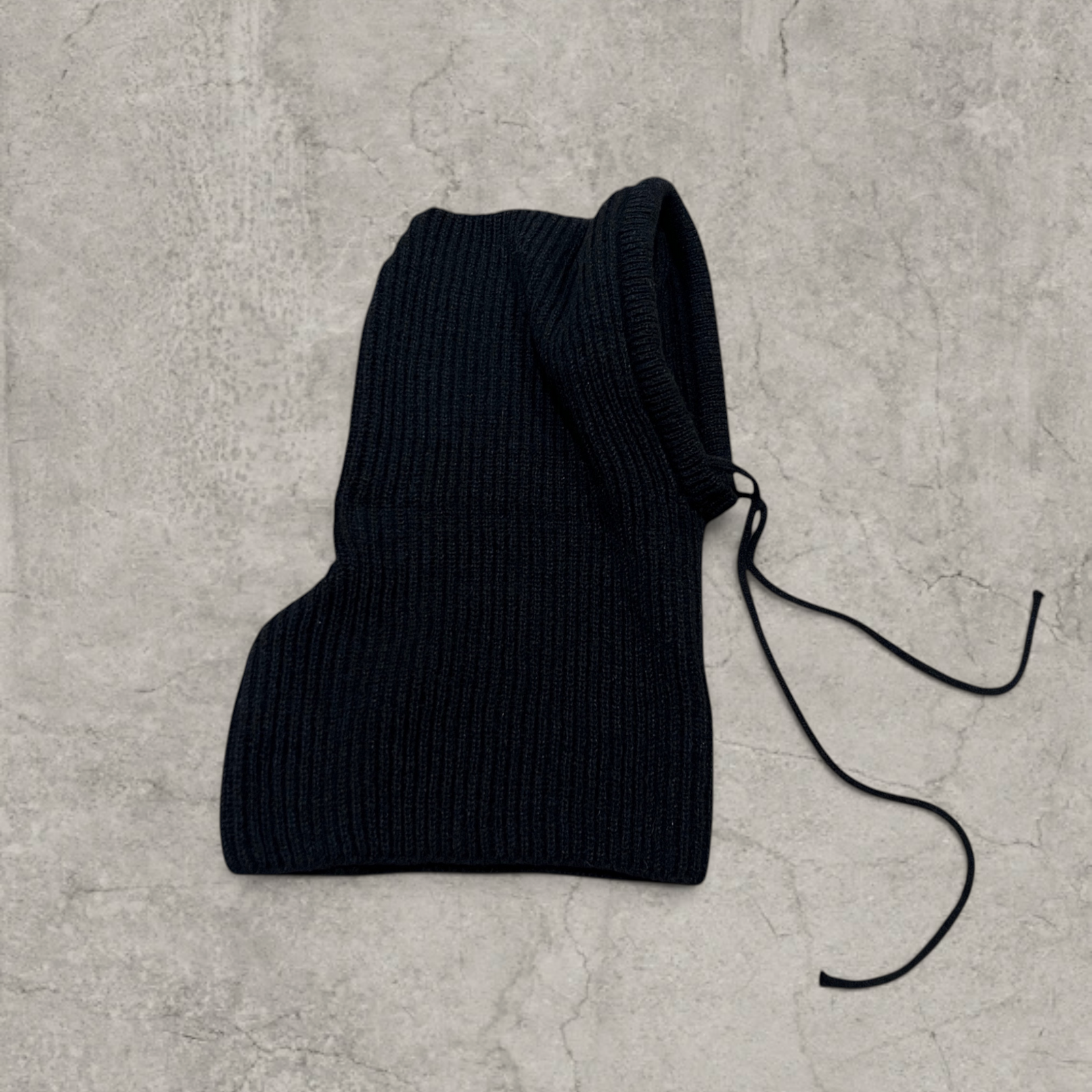 Knitted hooded snood scarf bonnet hat with drawstring in black.