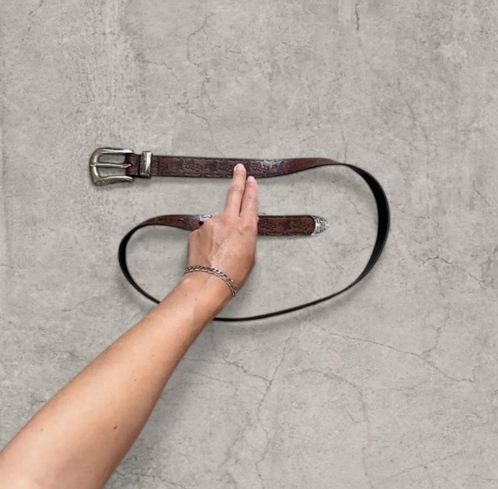 Vintage style faux leather western cowboy belt in brown with silver trim. 103cm.