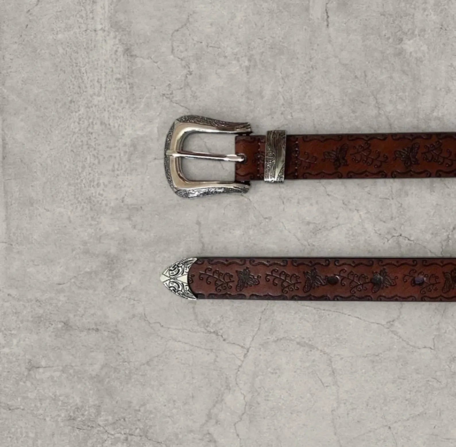 Vintage style faux leather western cowboy belt in brown with silver trim. 103cm.