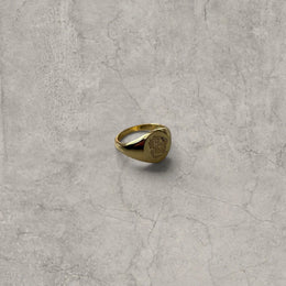 Cool vintage style gold colour stainless steel signet ring with engraved emblem.