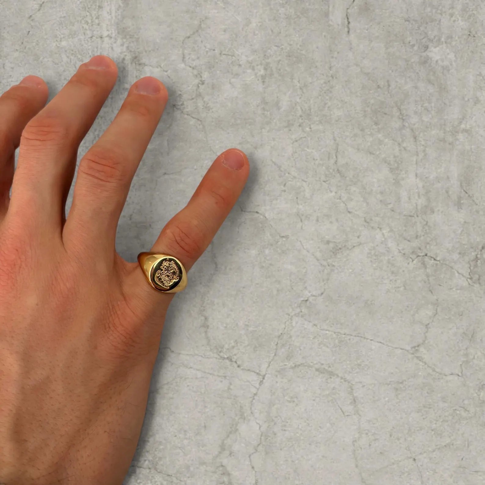 Cool vintage style gold colour stainless steel signet ring with engraved emblem.