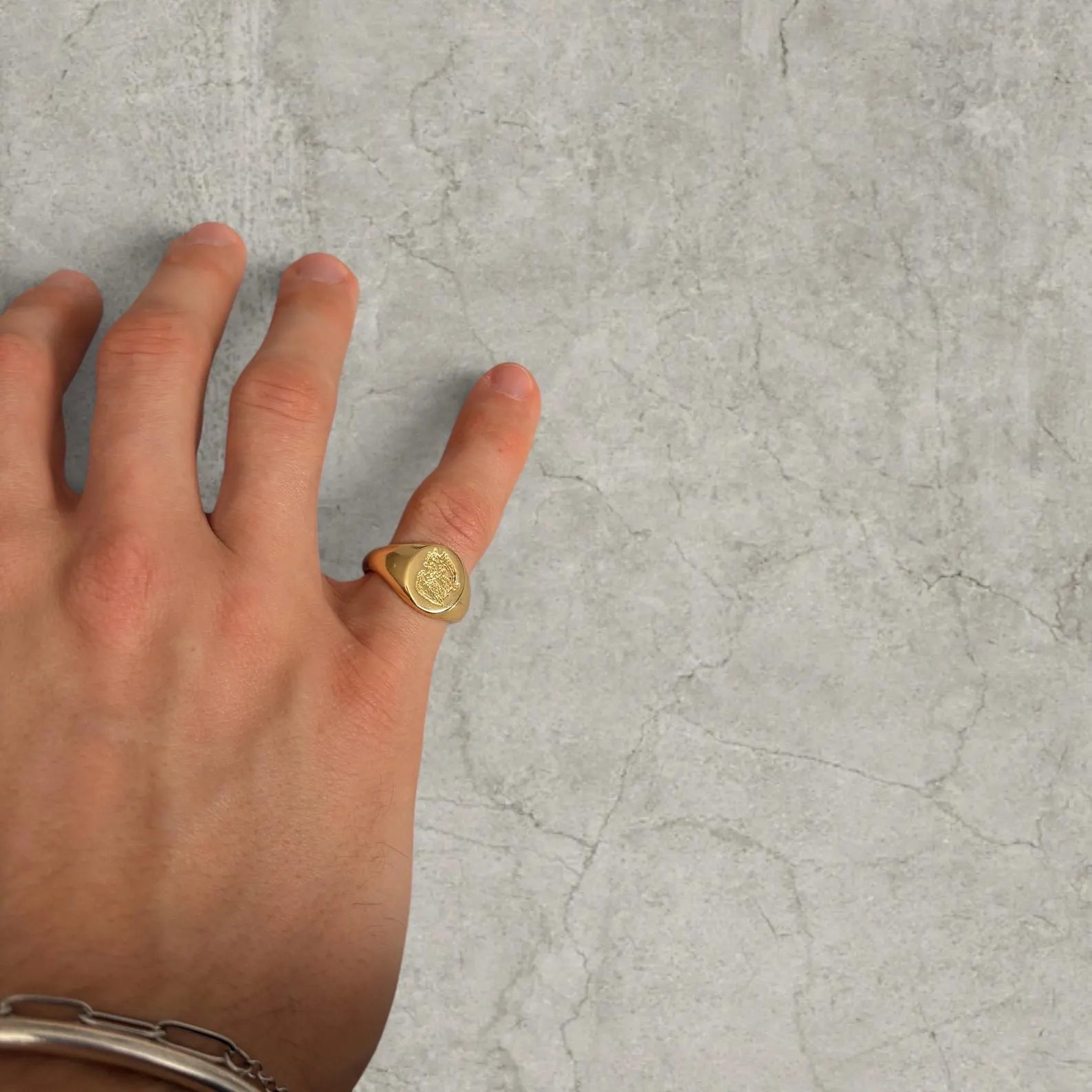 Cool vintage style gold colour stainless steel signet ring with engraved emblem.