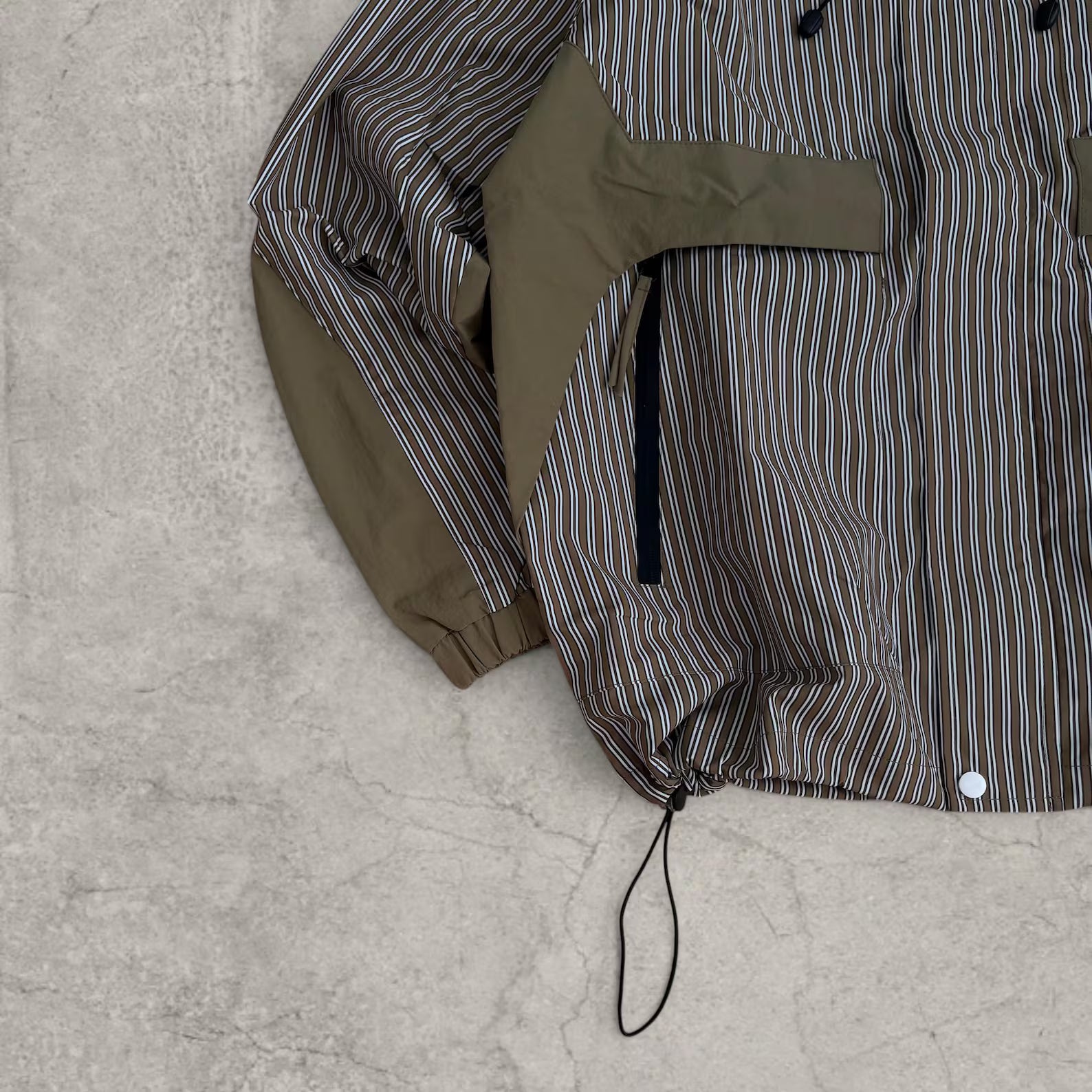 Insane skate khaki green/brown striped gorpcore jacket with hood, zip up and toggle.