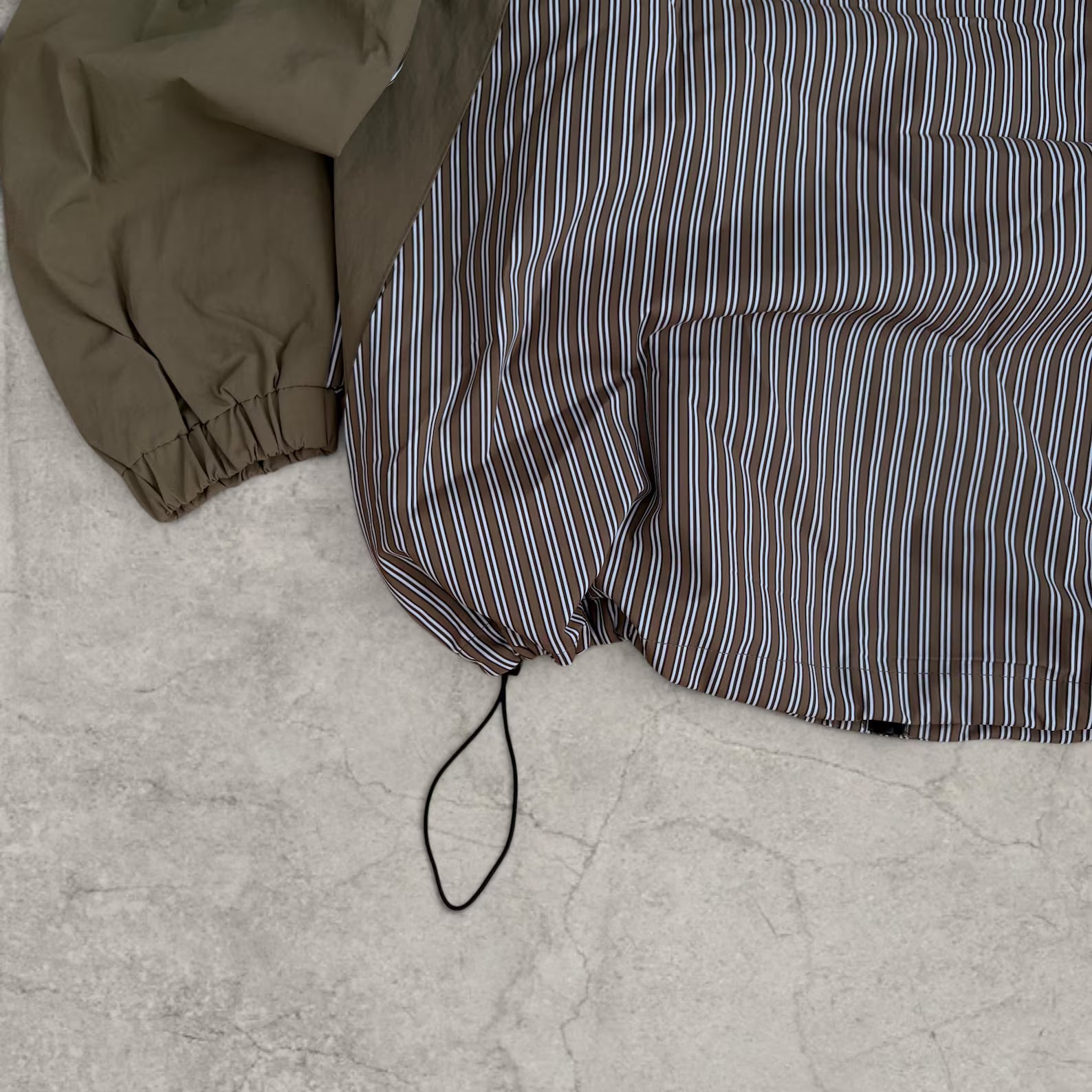 Insane skate khaki green/brown striped gorpcore jacket with hood, zip up and toggle.
