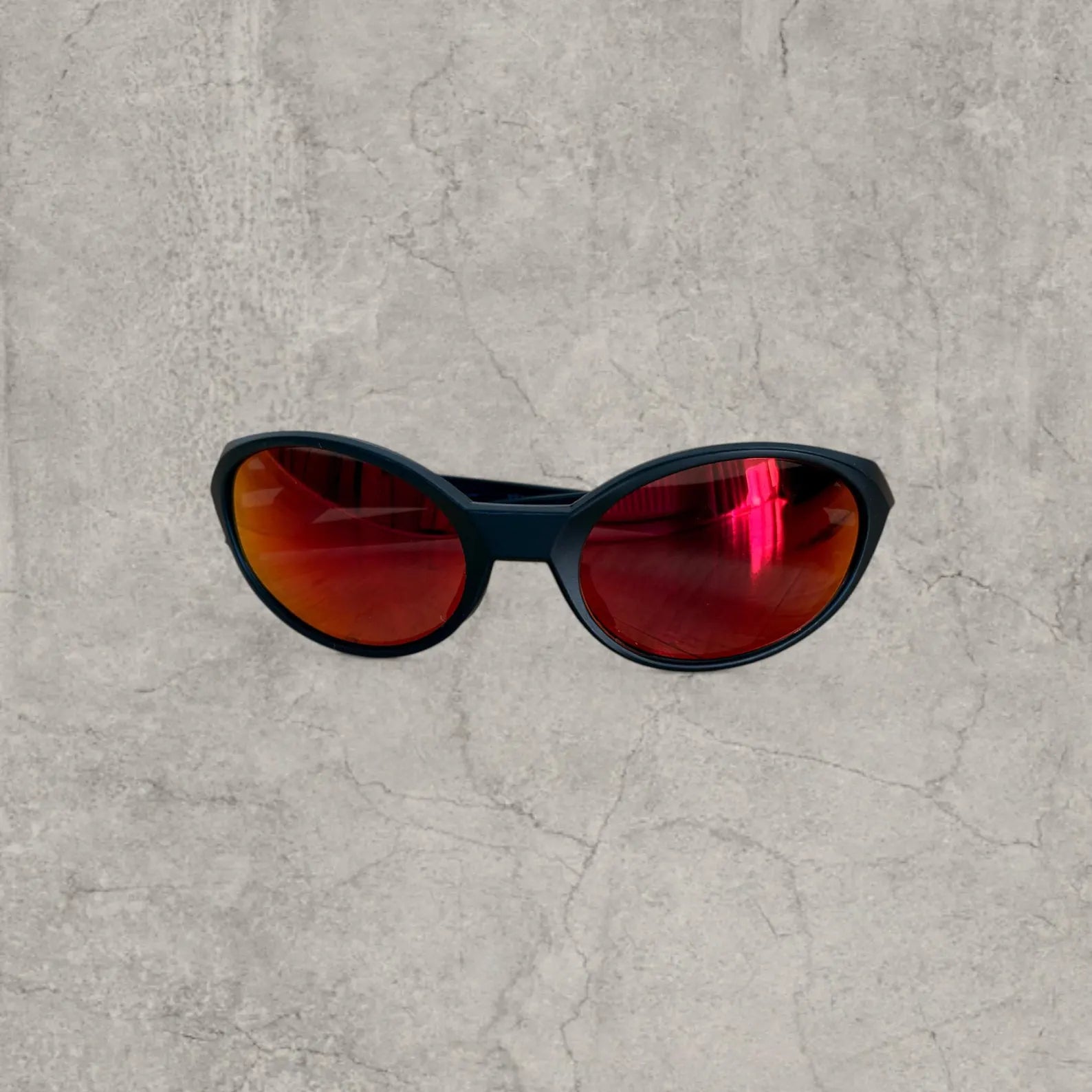 Insane UV400 sunglasses in black with orange/red reflective lense. One size.